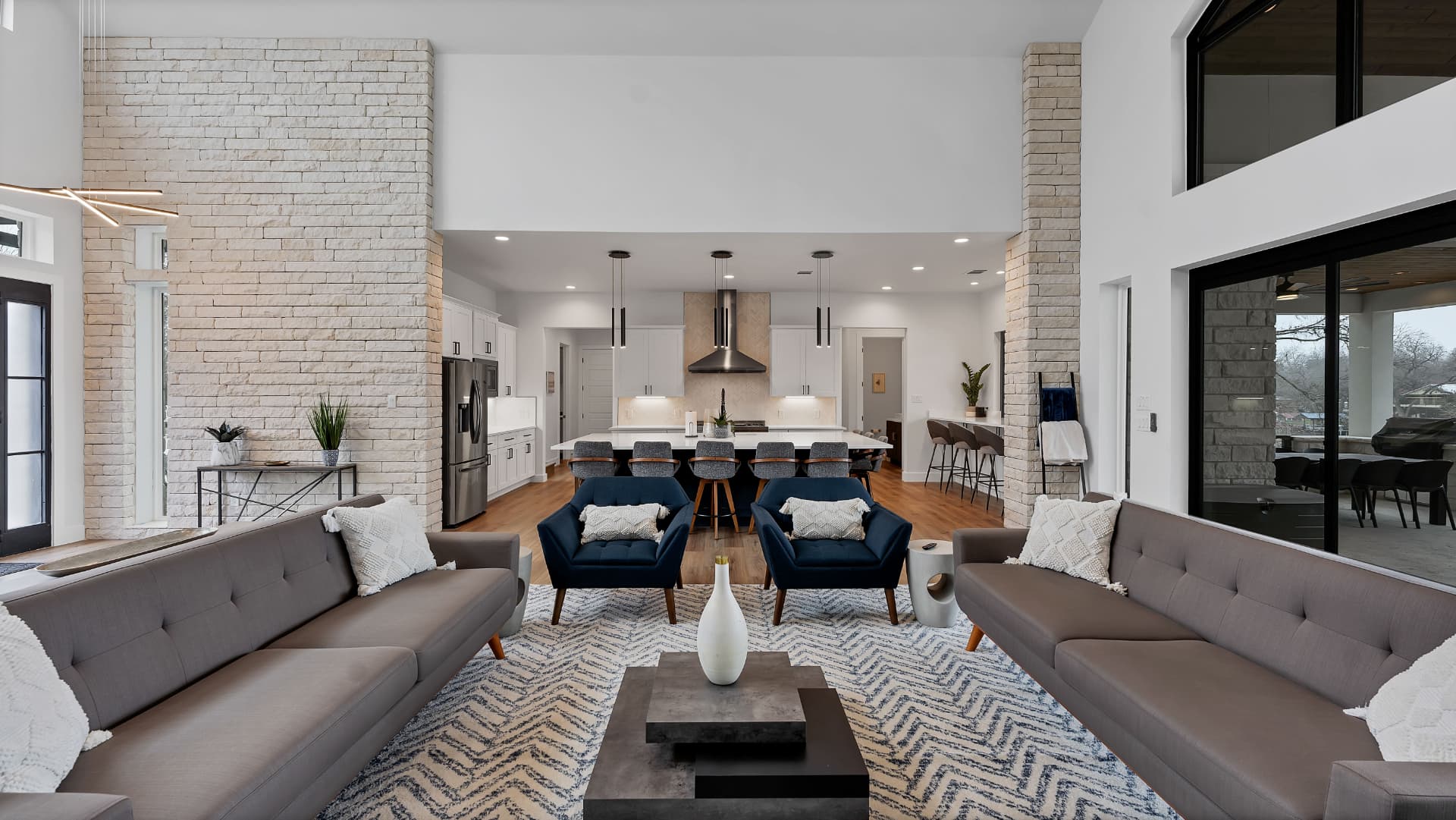 Living room looking toward the kitchen between two stone columns