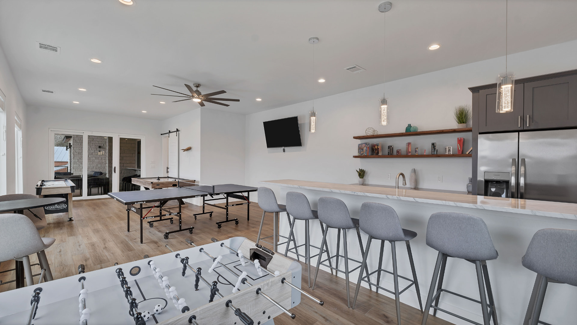 Game room with a bar, foosball, and table tennis