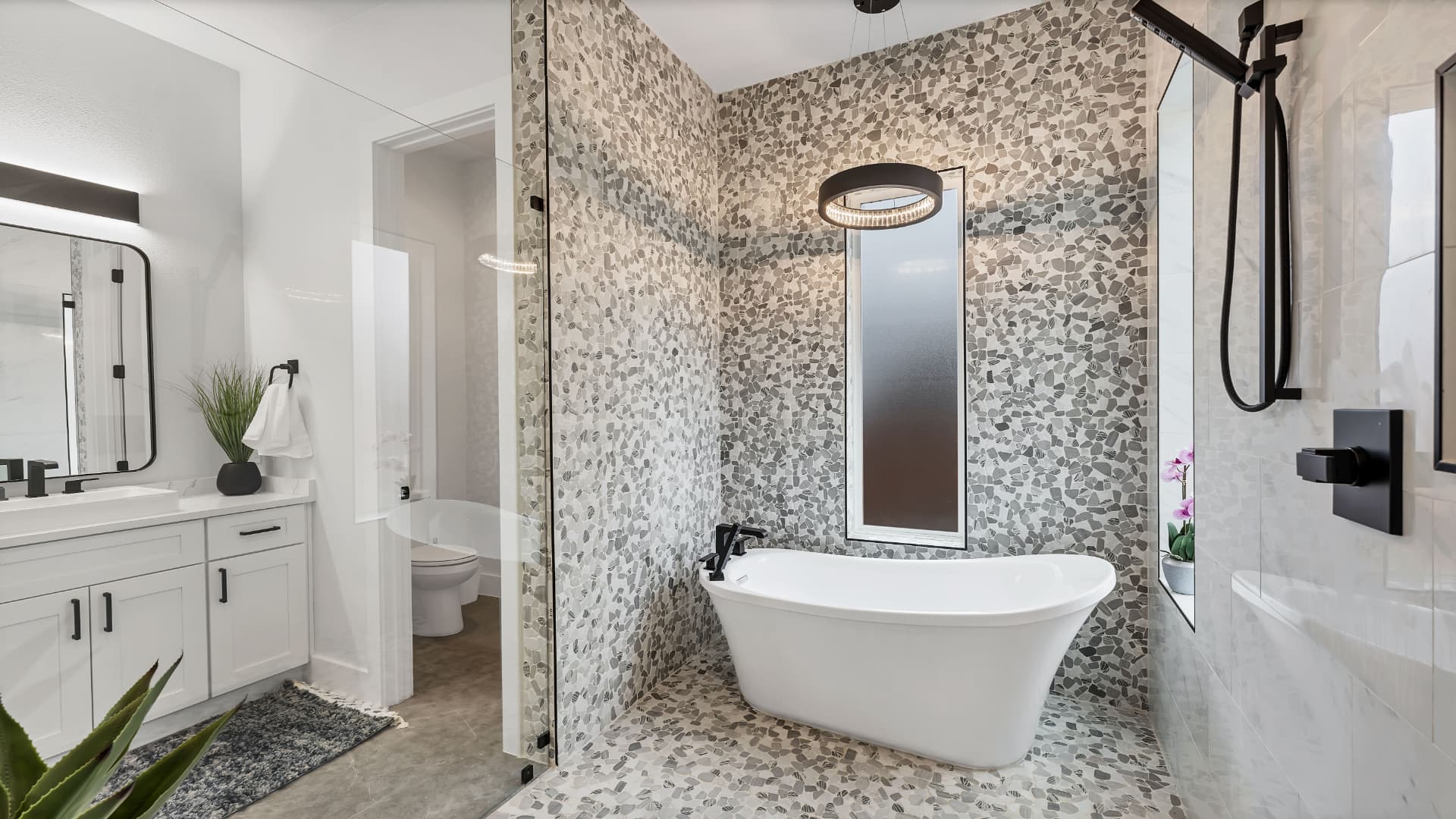 Bathroom with a freestanding tub set into pebble tile and a walk in shower